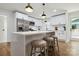Kitchen features white cabinets, stainless steel appliances, quartz countertops, and a center island with seating at 3801 Rea Rd, Charlotte, NC 28226