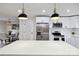 Modern kitchen features stainless steel appliances, white cabinets, quartz countertops and a dining area at 3801 Rea Rd, Charlotte, NC 28226