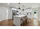 Modern kitchen with white cabinets, quartz countertops, stainless steel appliances, and a large center island at 3801 Rea Rd, Charlotte, NC 28226
