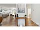 Open-concept living area with hardwood floors, modern decor, and seamless kitchen access at 3801 Rea Rd, Charlotte, NC 28226