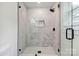 Modern shower featuring black hardware, glass door, and white marble tile at 3801 Rea Rd, Charlotte, NC 28226