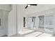 Bright sun room features all-white brick, flooring, and ceiling fan, creating a cozy indoor-outdoor living space at 3801 Rea Rd, Charlotte, NC 28226