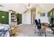 Open bedroom featuring modern desk and chair plus shelving, a guitar, and ample storage space at 4121 Cedar Point Ave # 28, Stallings, NC 28104