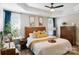 Serene bedroom with a wooden bed frame, soft lighting, and a ceiling fan at 4121 Cedar Point Ave # 28, Stallings, NC 28104