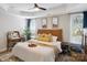 Comfortable bedroom featuring a wooden bed frame, soft lighting, and bright windows at 4121 Cedar Point Ave # 28, Stallings, NC 28104