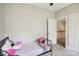 Comfortable bedroom with carpet, door to a hall, and bed with stylish black frame at 4121 Cedar Point Ave # 28, Stallings, NC 28104