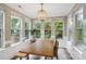 Sunlit dining area with large windows, a wooden table, and a unique light fixture at 4121 Cedar Point Ave # 28, Stallings, NC 28104