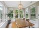 Bright dining area featuring many large windows, a wooden table, and an elegant chandelier at 4121 Cedar Point Ave # 28, Stallings, NC 28104