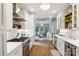 Modern kitchen featuring white cabinets, stainless steel appliances, and an elegant chandelier at 4121 Cedar Point Ave # 28, Stallings, NC 28104