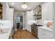 Bright kitchen with white cabinets, stainless steel appliances, and a decorative chandelier at 4121 Cedar Point Ave # 28, Stallings, NC 28104