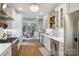 Modern kitchen featuring white cabinets, stainless steel appliances, and an elegant chandelier at 4121 Cedar Point Ave # 28, Stallings, NC 28104
