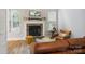 Cozy living room with a stone fireplace, comfortable seating, and ample natural light at 4121 Cedar Point Ave # 28, Stallings, NC 28104