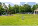 A neighborhood playground featuring swings, a slide, and climbing equipment with pool in background at 4121 Cedar Point Ave # 28, Stallings, NC 28104