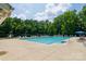 Large community pool area with lounge chairs and umbrellas, perfect for summertime relaxation and recreation at 4121 Cedar Point Ave # 28, Stallings, NC 28104