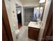 Clean bathroom with white tile, neutral walls, a single sink vanity, and a shower-tub combination at 4574 Ivy Run Ln, Denver, NC 28037