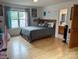 Well-lit bedroom with hard wood floors, a ceiling fan, neutral walls, and access to an attached bathroom at 4574 Ivy Run Ln, Denver, NC 28037