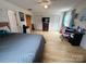 Comfortable bedroom with hardwood floors, natural light, and a nearby desk and study area at 4574 Ivy Run Ln, Denver, NC 28037