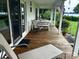 Covered porch with outdoor seating and a view of the lake at 4574 Ivy Run Ln, Denver, NC 28037