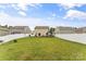 Spacious backyard with a well-manicured lawn, white vinyl fence, and a deck at 515 Benford Ln, Stanley, NC 28164