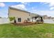 Large backyard with a patio, a cozy gazebo, and a lush green lawn at 515 Benford Ln, Stanley, NC 28164
