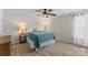 Cozy bedroom featuring a blue quilt, carpet, and lamp at 515 Benford Ln, Stanley, NC 28164