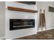 Stylish electric fireplace with a shiplap surround and decorative mantle, adding warmth and character to the room at 515 Benford Ln, Stanley, NC 28164
