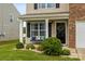 Inviting front porch with a bench seating area, attractive landscaping, and a welcoming front door with a wreath at 515 Benford Ln, Stanley, NC 28164