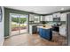 Modern kitchen with white cabinets, stainless steel appliances, and a center island, opening to the backyard at 515 Benford Ln, Stanley, NC 28164