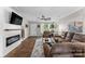Well-lit living room with a decorative fireplace, hardwood floors, and comfortable furniture, perfect for relaxation at 515 Benford Ln, Stanley, NC 28164