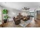 Bright living room featuring hardwood floors, modern decor, and an open layout connecting to the dining area at 515 Benford Ln, Stanley, NC 28164