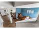 Open-concept living room and dining room featuring hardwood floors, neutral paint, and plenty of natural light at 515 Benford Ln, Stanley, NC 28164