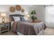 Cozy main bedroom with a gray upholstered headboard, decorative wall art, and a wooden nightstand at 515 Benford Ln, Stanley, NC 28164