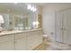Bright bathroom with double vanity, large mirror, and neutral finishes at 525 Queens Rd, Charlotte, NC 28207