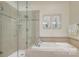 Relaxing bathroom featuring a soaking tub and separate shower with glass door at 525 Queens Rd, Charlotte, NC 28207