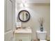 Half bathroom with a round mirror, neutral colored walls, and a toilet, designed for compact functionality at 525 Queens Rd, Charlotte, NC 28207