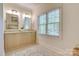 Bright bathroom featuring a double vanity, neutral color palette, and a large window for ample natural light at 525 Queens Rd, Charlotte, NC 28207