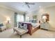Spacious bedroom featuring a king bed, bench, and neutral finishes at 525 Queens Rd, Charlotte, NC 28207