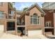 Beautiful multi-story brick home showcasing an attached garage, balcony, and classic architectural details at 525 Queens Rd, Charlotte, NC 28207