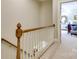 Upstairs hallway with wood banister, carpeted floors, and view into a bedroom at 525 Queens Rd, Charlotte, NC 28207