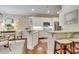 Bright kitchen with white cabinets, breakfast bar, stainless appliances, and hardwood flooring at 525 Queens Rd, Charlotte, NC 28207