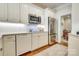 Updated kitchen features white cabinets, stainless steel appliances, and hardwood floors at 525 Queens Rd, Charlotte, NC 28207