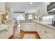 Open kitchen with white cabinets, stainless appliances, and hardwood floors at 525 Queens Rd, Charlotte, NC 28207