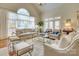 Light filled living room with lots of seating, large window and glass coffee table at 525 Queens Rd, Charlotte, NC 28207