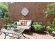 Charming brick patio with stylish seating, a glass table, and lush greenery for outdoor enjoyment and relaxation at 525 Queens Rd, Charlotte, NC 28207