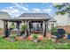 Charming backyard with a covered patio, complete with cozy seating and outdoor dining area at 5927 Leawood Run Ct, Charlotte, NC 28269