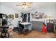 Cozy bedroom featuring a ceiling fan, wood laminate flooring, and eclectic furnishings at 5927 Leawood Run Ct, Charlotte, NC 28269