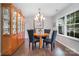 Elegant dining room with hardwood floors, a chandelier, and a china cabinet, perfect for Gathering gatherings at 5927 Leawood Run Ct, Charlotte, NC 28269