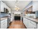 Bright kitchen with stainless steel appliances, white cabinets, and a functional island for meal preparation at 5927 Leawood Run Ct, Charlotte, NC 28269