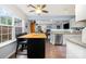 Open concept kitchen featuring an island with seating and views into the adjacent living space at 5927 Leawood Run Ct, Charlotte, NC 28269