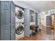 Convenient laundry area with stacked washer and dryer units and storage solutions at 5927 Leawood Run Ct, Charlotte, NC 28269